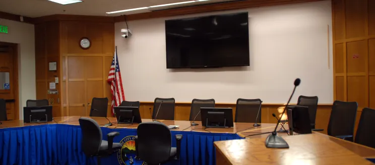 Table and seats set up inside the David Gehard Public Meeting Room