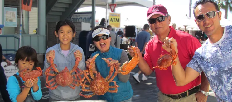 Family holds up crabs