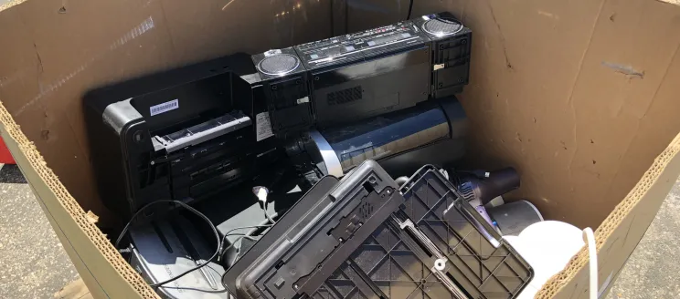 Box filled with an old printer, boombox, monitor to be recycled