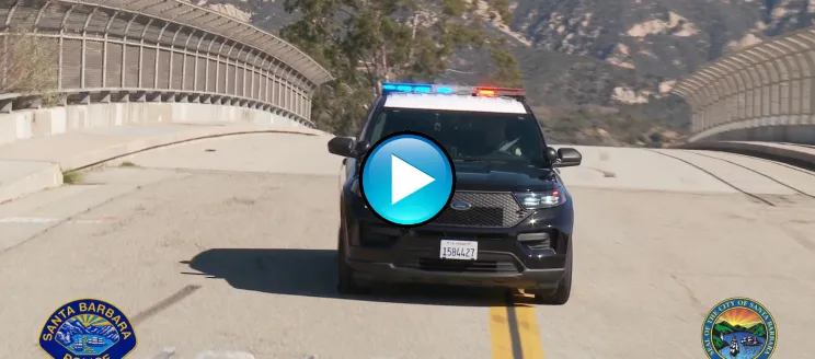 This image shows a police vehicle with lights on in motion to demonstrate the new siren