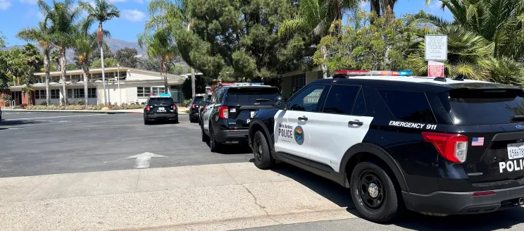 This image shows a line of SBPD vehicles outside of Bishop Diego HS,  responding to what was deemed a false report of an active shooter