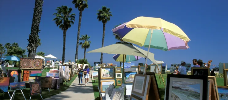 People stroll along the sidewalk of Chase Palm Park during the Santa Barbara Arts and Crafts Shows