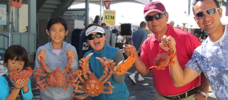 Family holding various crabs