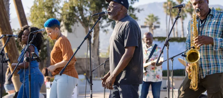 Musical group playing music in the park. 