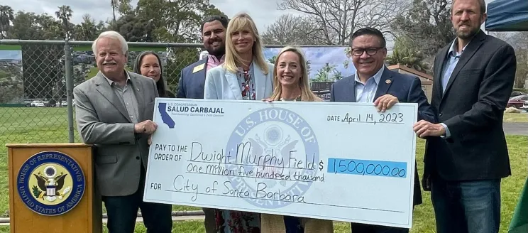 Image shows Congressman Carbajal with City officials and a large novelty check