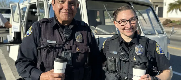 Two officers holding coffee