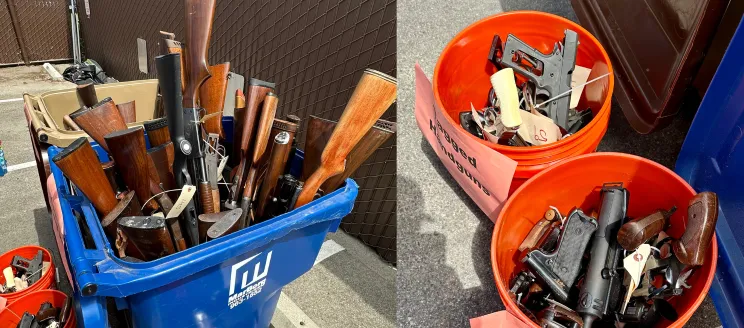 Image shows a garbage can filled with donated riffles and two buckets filled with handguns collected at the Gun Buy Back