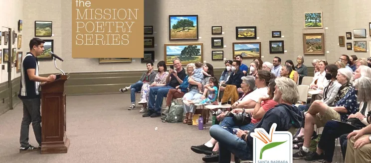 Image shows a lecturer addresses a large crowd in the Faulkner Gallery with a tan and white graphic that reads "Mission Poetry Series"