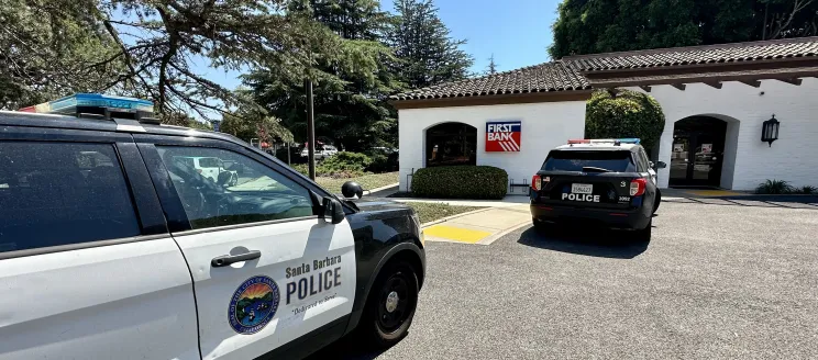 Two police cars in a bank parking lot