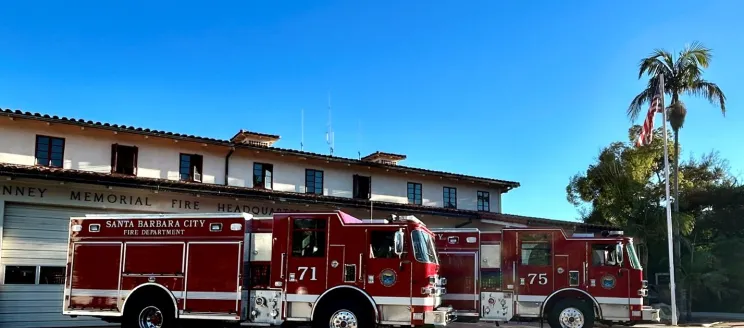 Two brand new shiny red fire engines in front of Fire Department Station 1  on carrillo street