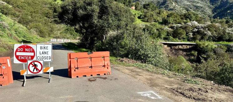 road closed signs with damaged roadway