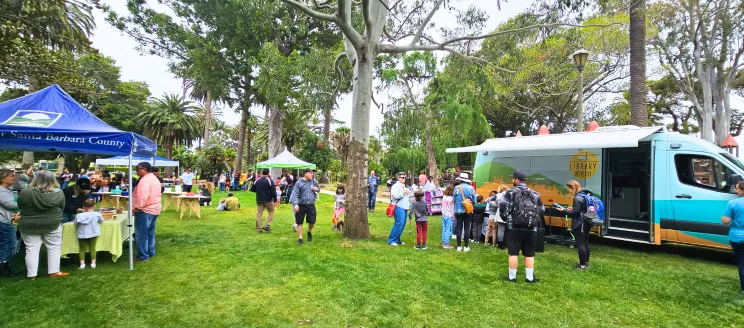 Summer Reading Kick Off at Alameda Park. Library on the Go van welcoming families enjoying a fun free event.