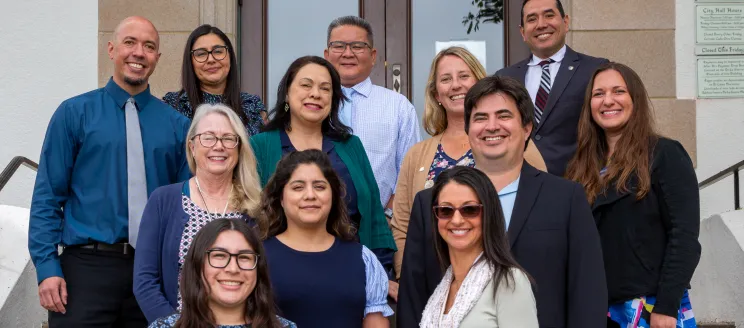 Human Resources Staff Photo. Employees smiling on steps of city hall.