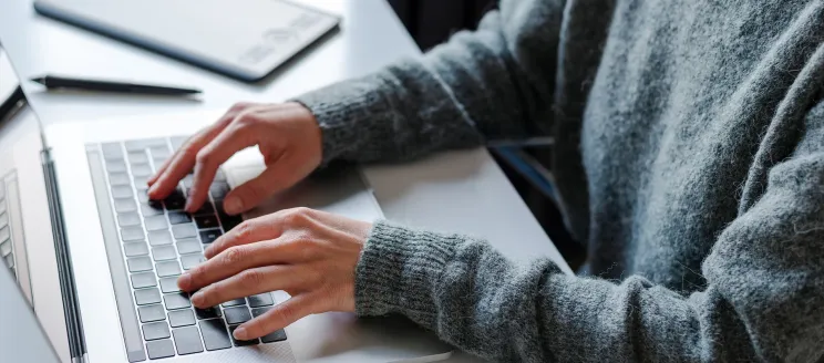 DigEplan News Item photo shows person on laptop to promote the new electronic plan review software