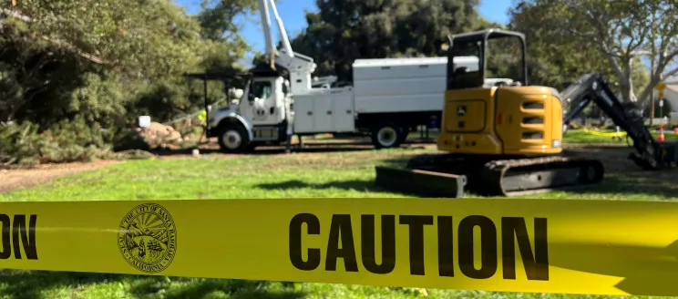 Oak Park Restoration construction equipment and caution tape in the work area.