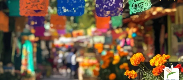 Papel Picado hanging in a paseo with marigolds in the foreground