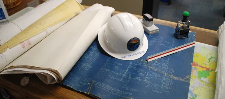 photo of plans and inspector hat