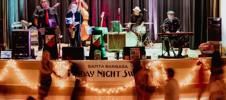 Participants swing dance to live music in the Carrillo Ballroom