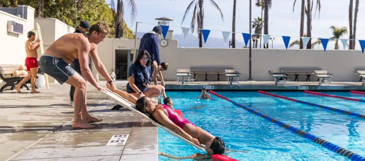 Lifeguard trainees practice water rescues at Los Baños del Mar.