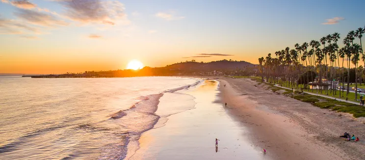 Photo of east beach at low tide view towards the sun setting over The Mesa