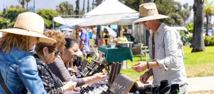 Vistiors to the Santa Barbara Arts and Crafts show browse handmade items