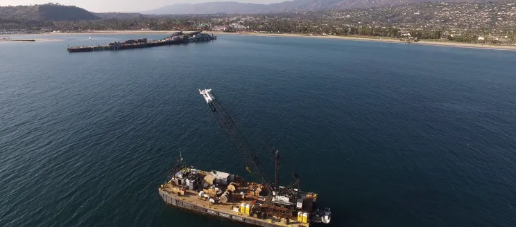 Barge near Stearns Wharf with Santa Barbara’s coastline in the background.