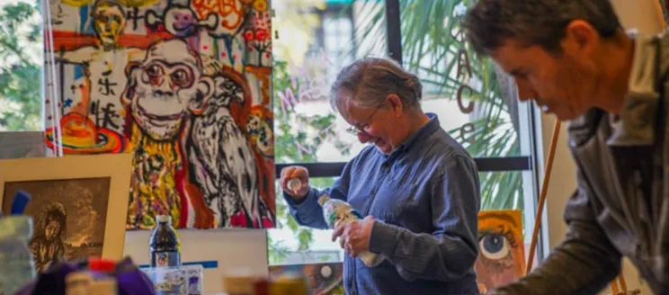 Participants painting at an activity of the Mental Wellness Center, a 2025-2026 grant recipient.
