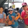 Family holds up crabs