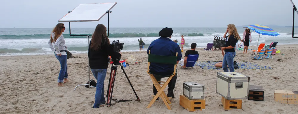 Creeks and City TV staff film a television ad at the beach