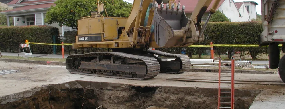 Heavy equipment in street installing Haley Street CDS (continuous deflection system) unit