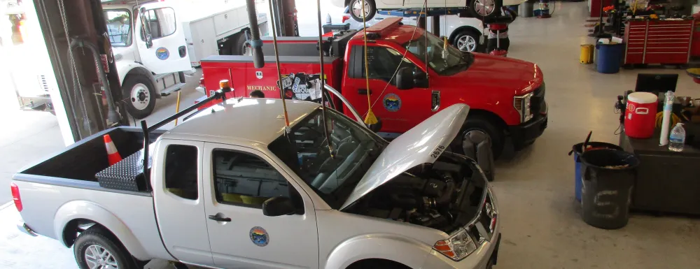 Overhead view of the Fleet Bay with two cars being serviced. 