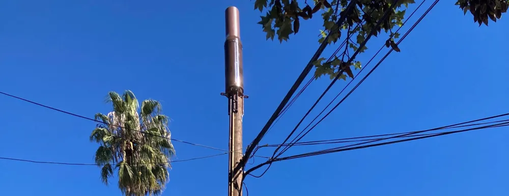 WOOD UTILITY POLE WITH SMALL CELL ON TOP