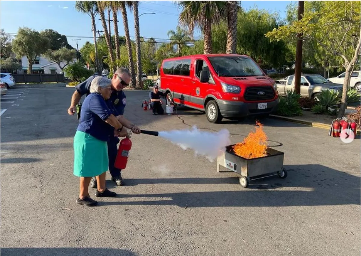 Woman practicing with fire extinguisher
