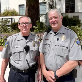 Two VIPs standing to the front of SBPD