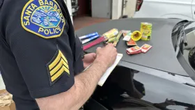 SBPD writing an Illegal Firework Citation. Fireworks on hood of a patrol car.