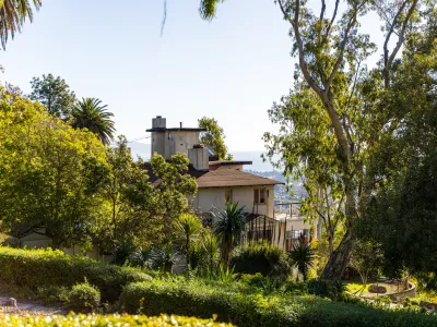 Franceschi House appears through trees