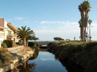 Picture of Sycamore Creek at Cabrillo Boulevard and El Escorial Villas on the left-hand side.